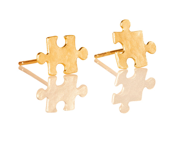 Golden puzzle earrings attached to the ear