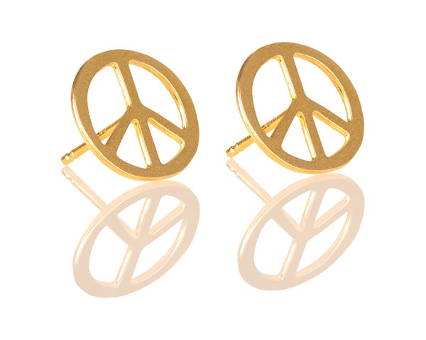 Gold PEACE earrings attached to the ear