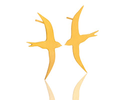 Gold flying bird earrings attached