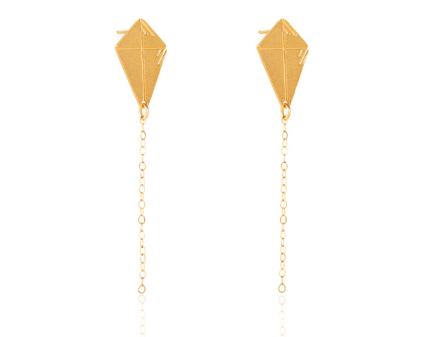 Gold kite earrings attached to the ear