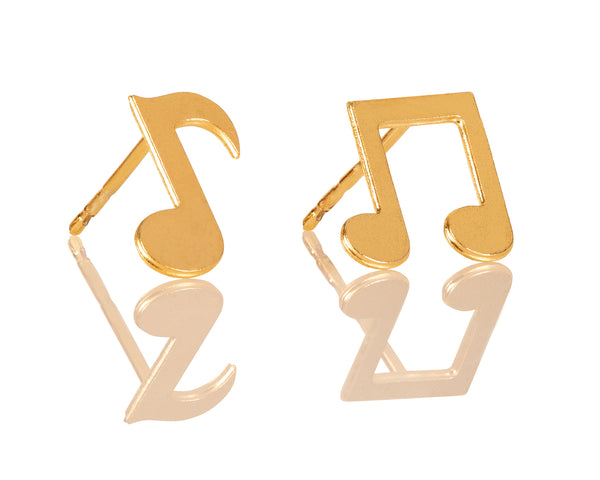 Earrings with different gold notes attached to the ear