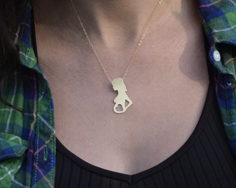 Gold necklace pregnant woman with a heart in her stomach