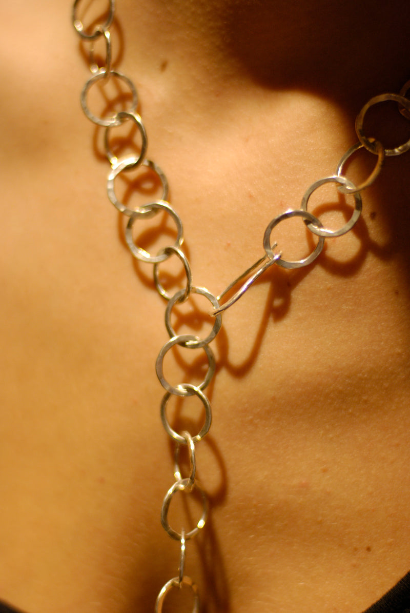A chain of hammered silver loops