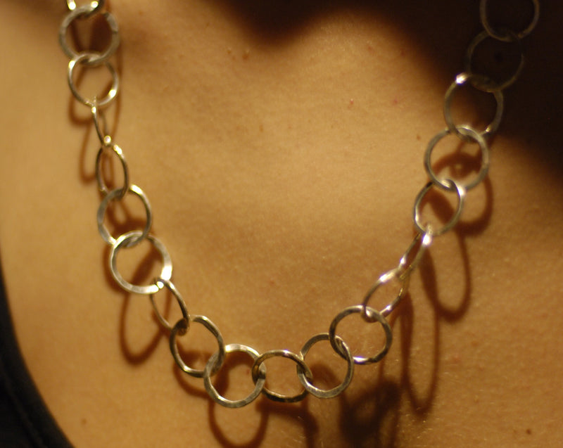 A chain of hammered silver loops