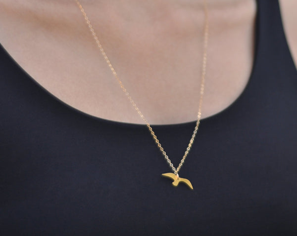 Gold flying bird necklace