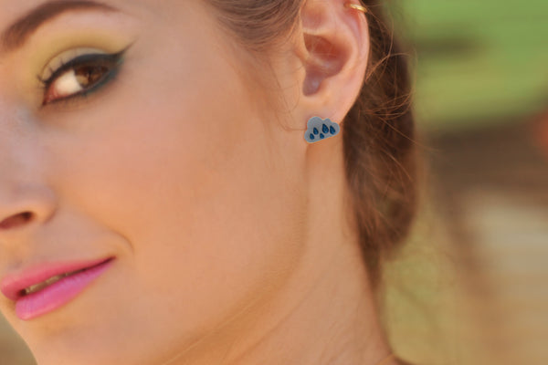 White cloud earrings with blue raindrops, close to the ear