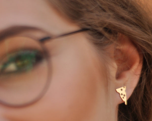 Yellow gold mouse and cheese earrings close to the ear