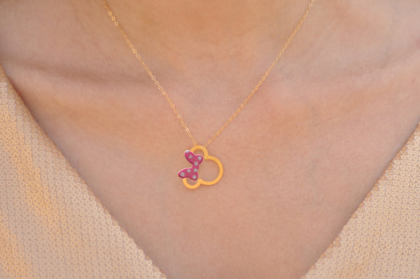 Gold Minnie Mouse necklace with a pink bow with dots