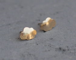 Gold cloud earrings close to the ear
