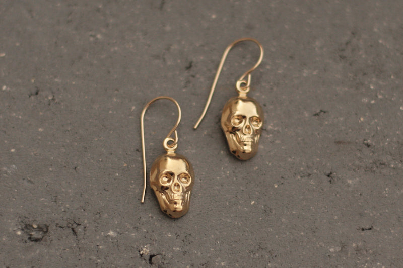Hanging gold skull earrings