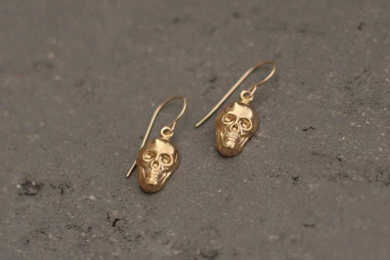 Hanging gold skull earrings