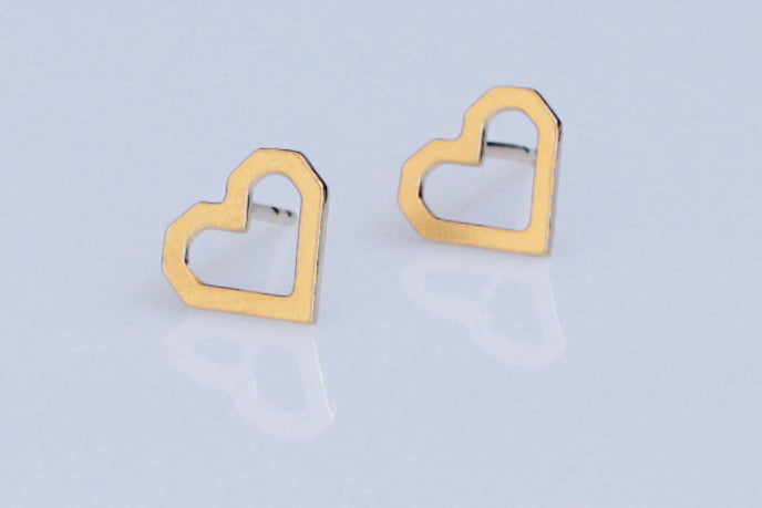 Pixelated heart earrings attached to the ear