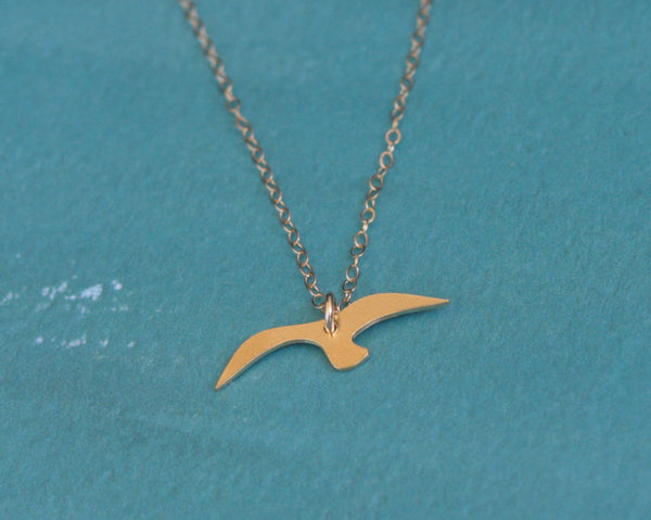 Gold flying bird necklace
