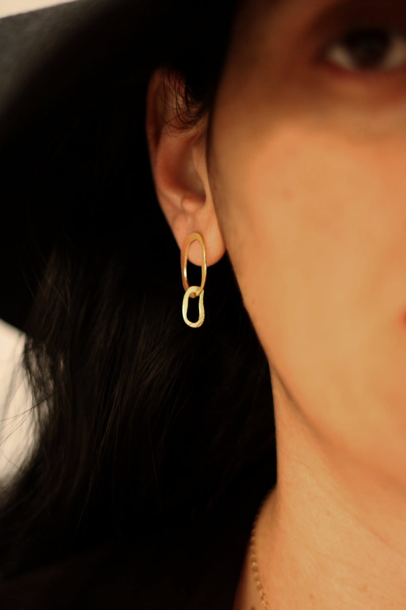 Double long oval earrings attached to the ear