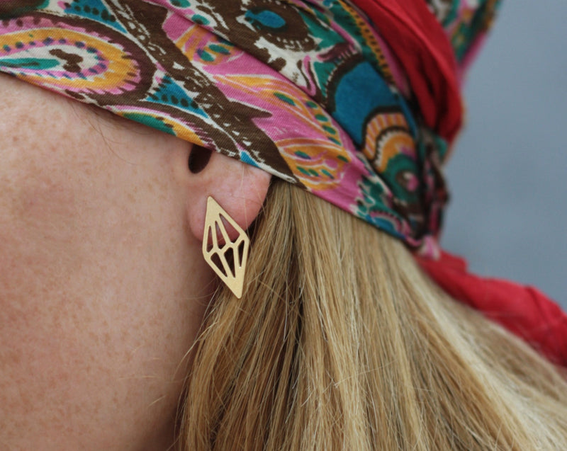 Geometric rhombus diamond earrings close to the ear