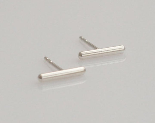 Silver stud earrings attached to the ear