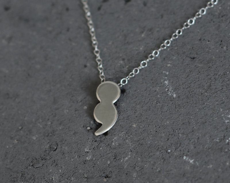 Silver dot comma necklace