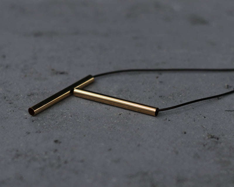 Gold bar necklace with long leather