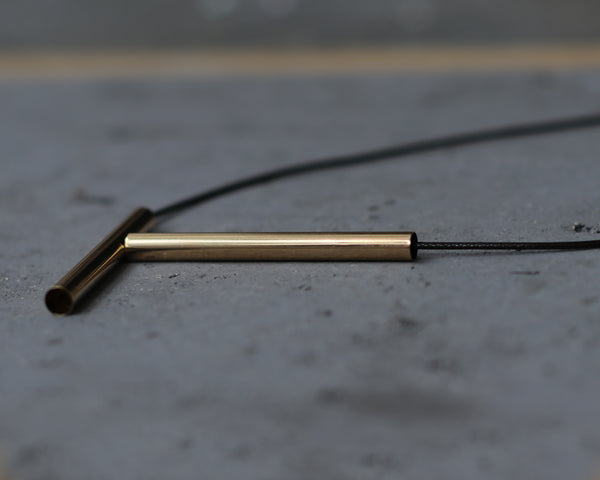 Gold bar necklace with long leather