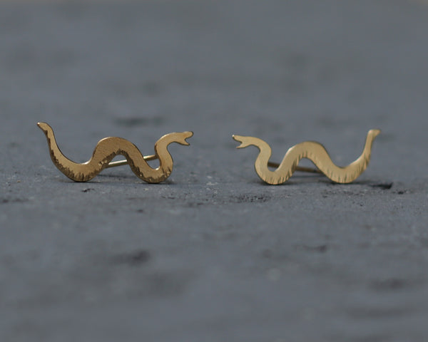 Gold serpentine snake earrings climbing