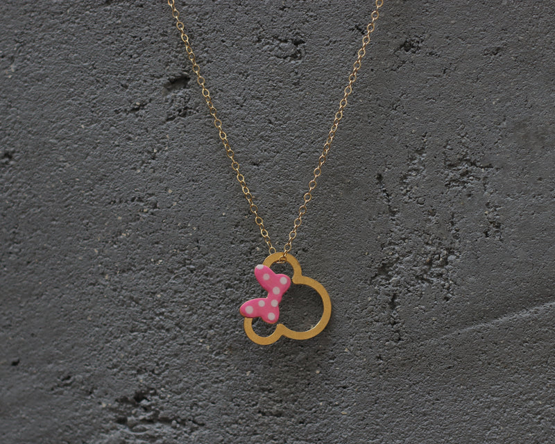 Gold Minnie Mouse necklace with a pink bow with dots