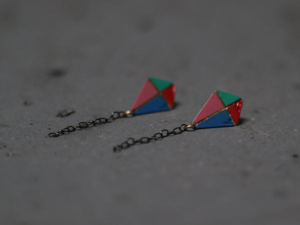 Long colorful kite earrings close to the ear