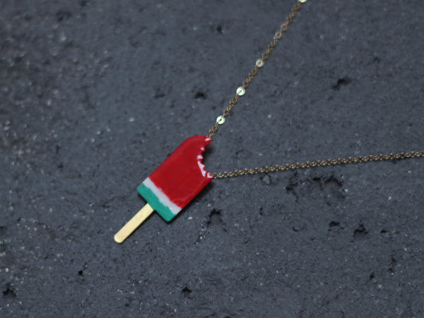 Colorful necklace of bitten watermelon popsicles