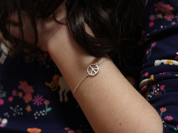 Silver bracelet with the peace symbol PEACE