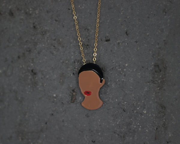 A necklace with a pendant of a colorful female portrait