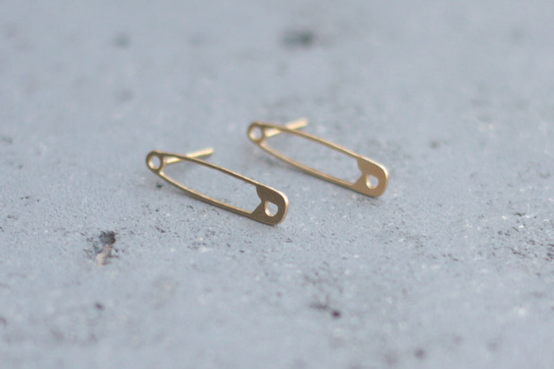 Safety pin earrings close to the ear