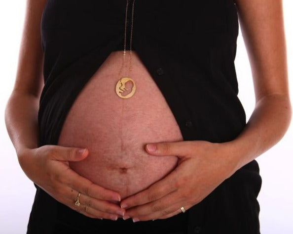 A gold chain passes through the womb