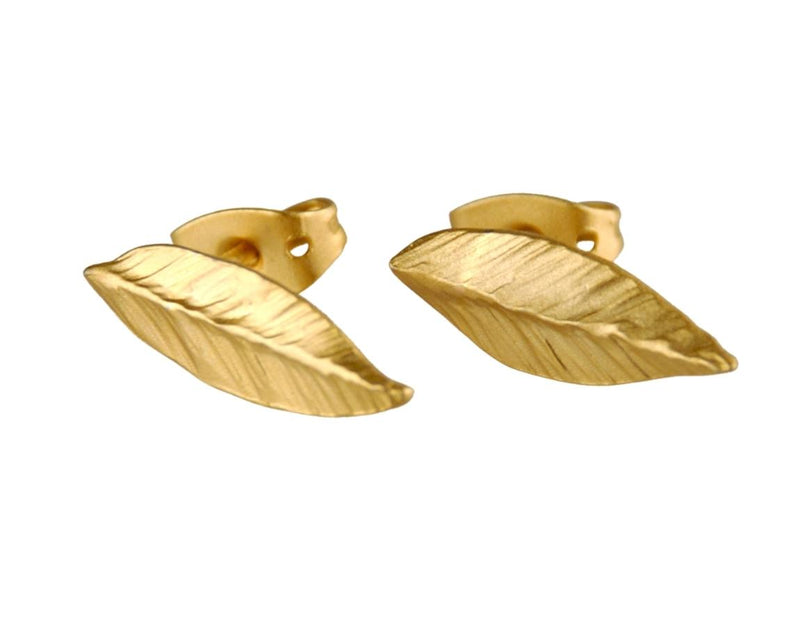 Golden leaf earrings attached to the ear